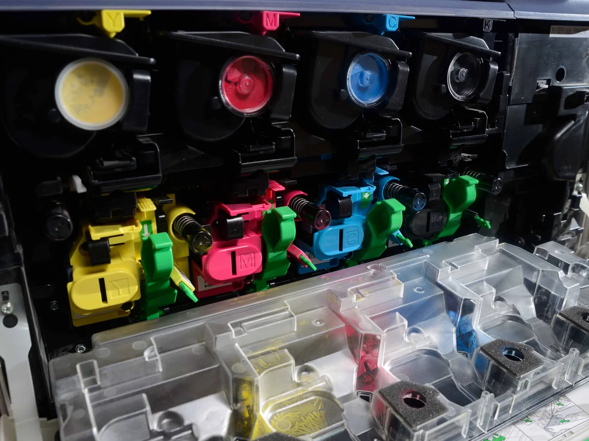 Yellow, magenta, cyan and black toner cartridges inside a color copier